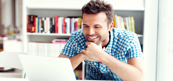 Male student looking at laptop displaying Boardvitals Rheumatology