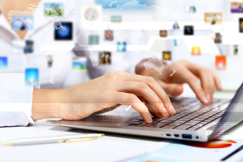 Female fingers on keyboard of laptop,conducting a search