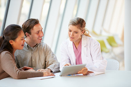 Female Doctor with a couple in a consultation